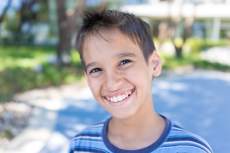 Child Smiling Outdoors