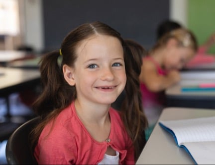Girl in class with notebook