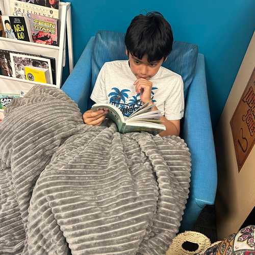 Student sitting comfortably and reading