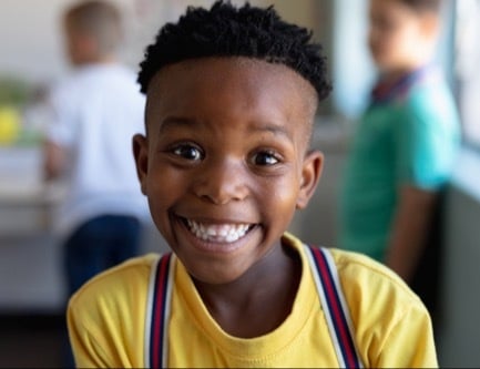 Smiling boy with yellow shirt