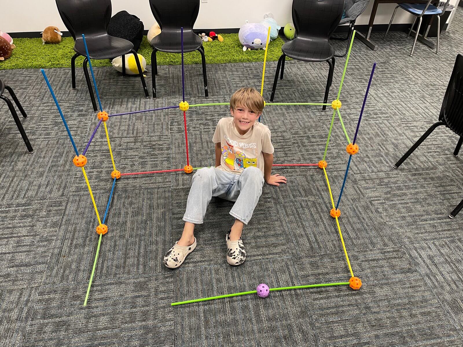 Student in toy structure