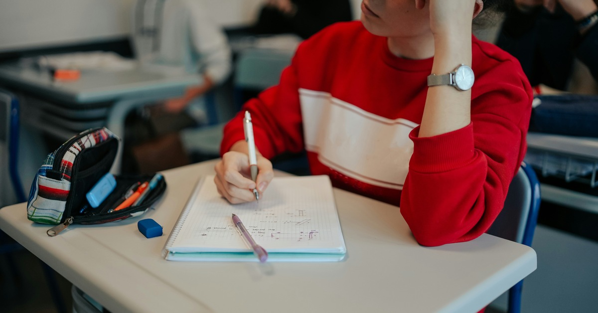 Student writing in a notebook while practicing executive functioning skills