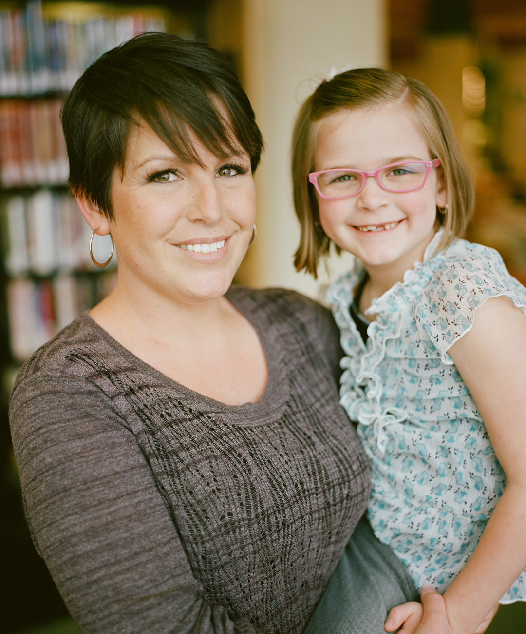 A smiling mother and daughter.